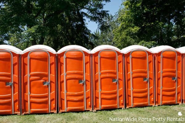 a lineup of clean and well-maintained portable loos for workers in Macomb, OK